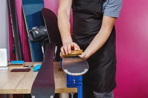Hands of ski workshop professional brushing equipment Stock Photos