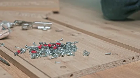 Hands of a skilled craftsman prepare to assemble wooden furniture by organizing Stock-Footage 327156101