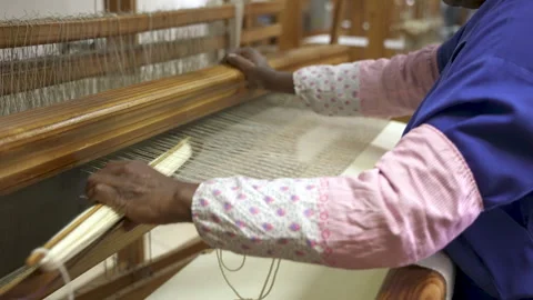 Hands Skillfully Adjusting Loom Threads in Artisan Workshop Stock Footage 336481319