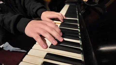 Hands Skillfully and Artfully Playing Piano Keys in a Captivating and Memorable Stock Footage 299996345