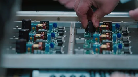 Hands Skillfully Assembling Electronic Circuit Board in Slow Motion Stockbeeldmateriaal 316574581