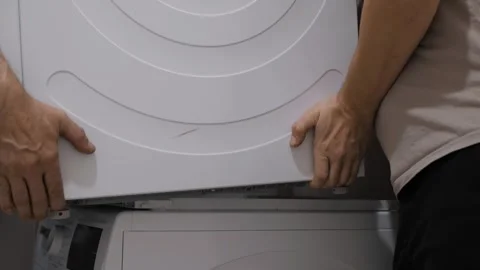 Hands Skillfully Installing Washer and Dryer Stock-Footage 303385549