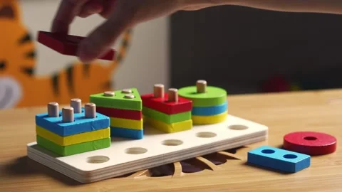 Hands skillfully manipulate colorful construction pieces Stock Footage 266751303