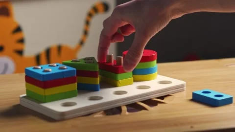 Hands skillfully manipulate colorful construction pieces Stock Footage 266751357