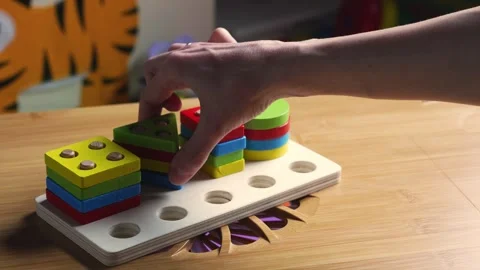 Hands skillfully manipulate colorful construction pieces Stock Footage 266751370