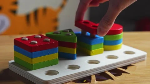 Hands skillfully manipulate colorful construction pieces Stock Footage 266751374