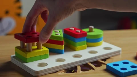 Hands skillfully manipulate colorful construction pieces Stock Footage 266751386