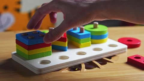 Hands skillfully manipulate colorful construction pieces Stock Footage 266751388