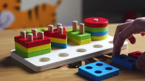 Hands skillfully manipulate colorful construction pieces Stock Footage 266751394