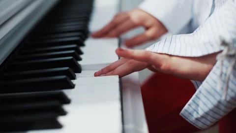 Hands Skillfully Playing the Piano while Dressed in Beautiful Traditional Attire Stock Footage 318708638