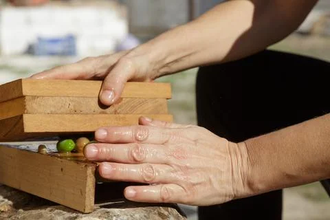 Hands Skillfully Preparing Fresh Ingredients with the Warmth of Natures Tou.. Stock Photos