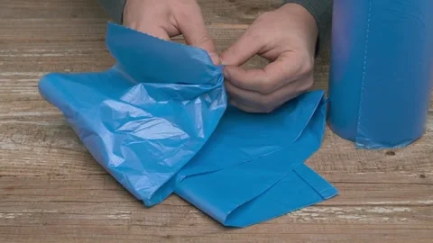 Hands Skillfully Utilizing Blue Plastic Wrap for Effective Packaging and Stock Footage 291287316