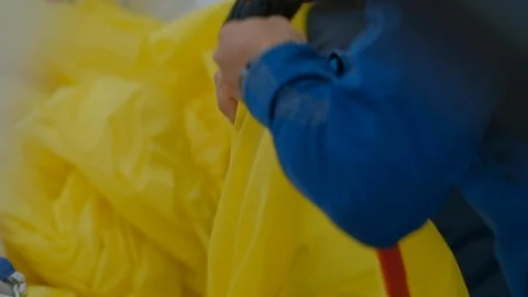Hands of the skipper fold yellow sail  on sailboat, yacht detail Stock Footage 109420373