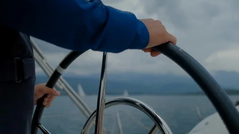 Hands of the skipper at the helm control of sailing boat Stock Footage 109420344