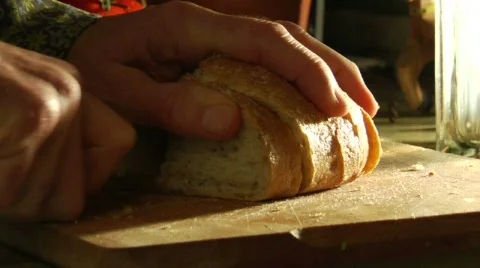 Hands slice loaves of bread. Stock Footage 554436