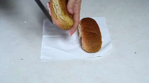 Hands Slicing Brown Bread Roll Stock Footage 342780458