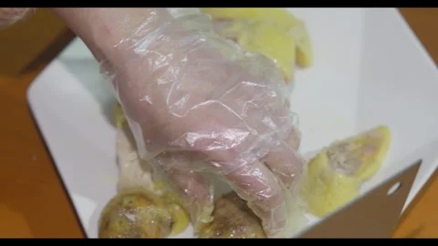 Hands slicing cooked chicken on white plate, close-up, no face Stock Footage 329685674