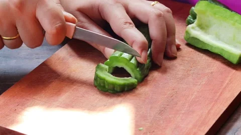 Hands slicing fresh bitter melon Stock Footage 340513976