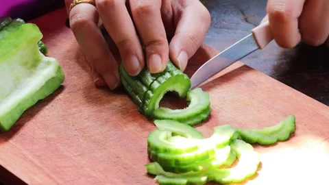Hands slicing fresh bitter melon Stock Footage 340514009