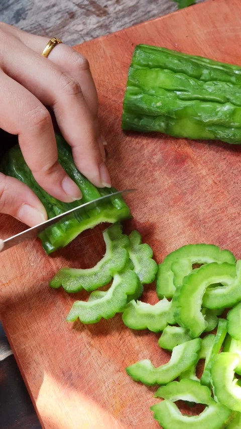Hands slicing fresh bitter melon Stock Footage 340514025