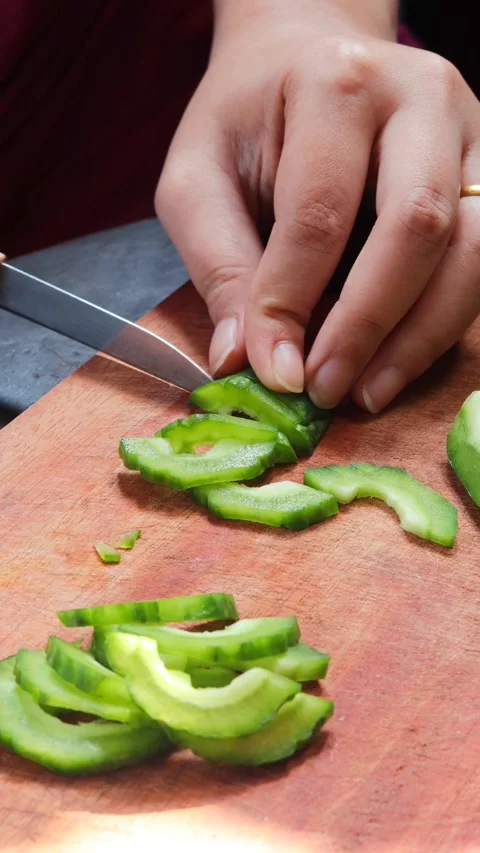 Hands slicing fresh bitter melon Stock Footage 340514078