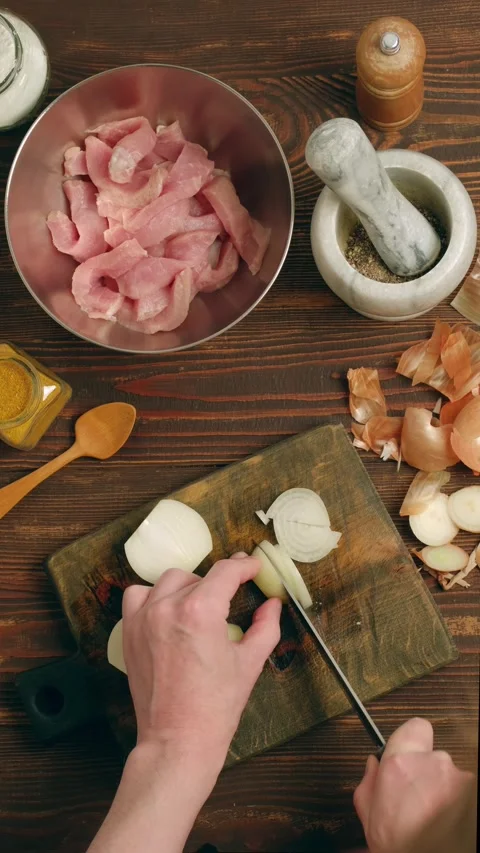 Hands slicing onion and chopping it with knife Stock Footage 345481507
