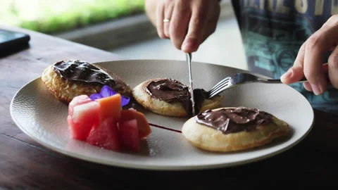 Hands slicing pancake with chocolate. Stock Footage 286082217