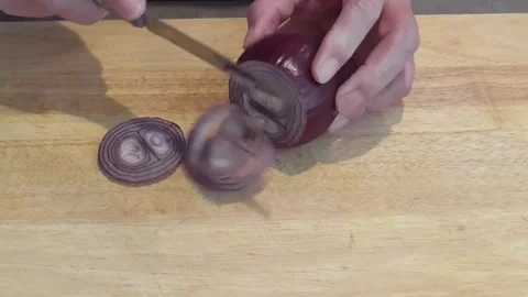 Hands Slicing Red Onion into Rings on Wooden Board Stock Footage 345227239