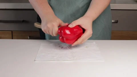 Hands slicing red pepper on clean surface, fresh vegetable glowing in natur.. Stock Footage 320955734
