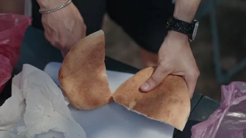 Hands Slicing Round Loaf of Bread Open With Knife on Cutting Board Stock Footage 340221430