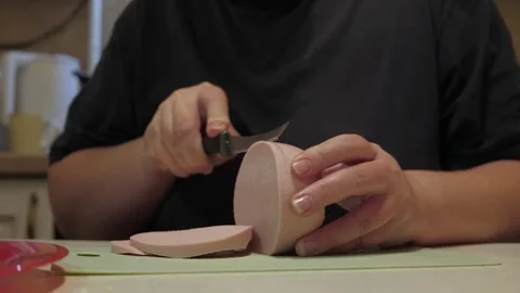 Hands slicing round sausage into thin even rounds 動画素材 342362071