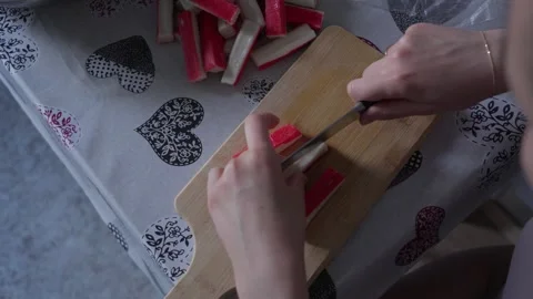 Hands Slicing Surimi Crab Sticks on Wooden Cutting Board Stock Footage 341767591