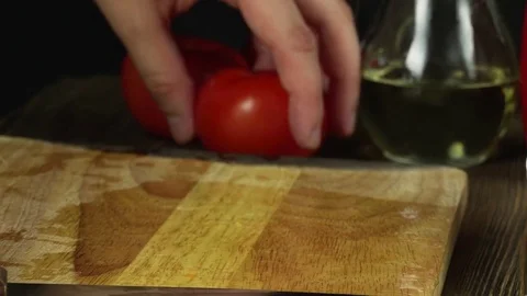 Hands slicing tomato in kitchen Stock Footage 74364155