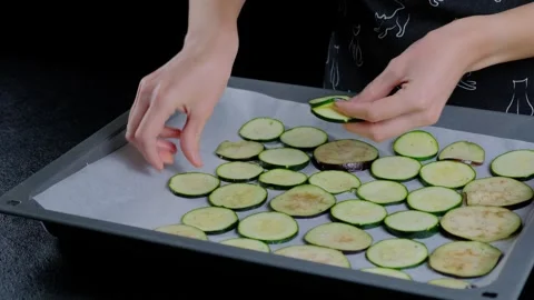 Hands Slicing Vegetables on Baking Sheet in Cooking Kitchen Stock Footage 341420628
