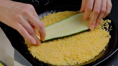 Hands Slicing Zucchini into Baking Pan with Crumbs in Cooking Stock Footage 341452957