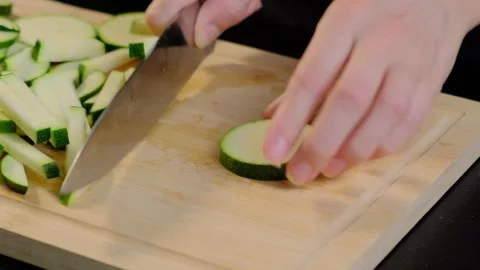 Hands Slicing Zucchini on Cutting Board in Cooking Kitchen Stock Footage 341420312