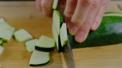 Hands Slicing Zucchini on Cutting Board in Cooking Kitchen Stock Footage 341456147