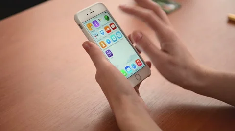 Hands sliding program icons on a iPhone 6 Stock Footage 47048486