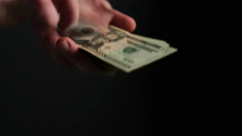 Hands sliding us dollars in 4k Stock Footage 217997555