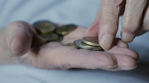 Hands with small change close-up. The concept of poverty. Women's hands with Stock Photos