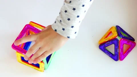 Hands of a small child playing with a magnetic constructor Stock Footage 161243315