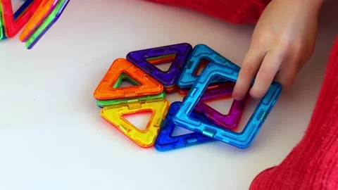 Hands of a small child playing with a magnetic constructor Stock Footage 161243693