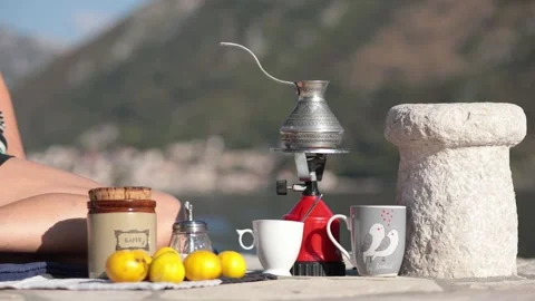 Hands with smartphone and coffee still life with cezve near old stone bollard Stock Footage 165079033