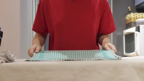 Hands smooth kitchen towel before steam ironing 스톡 동영상 337952222