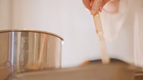 Hands smoothing batter into baking pans carefully. Detailed view of person Stock Footage 346395384
