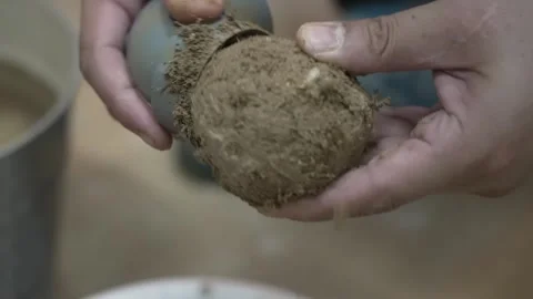 Hands Smoothing an Earth Sphere with a Glass Bottle Stock Footage 340901098