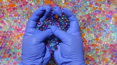 Hands smoothly pick up orbis on the background of of colored orbis. Part10.14 Stock Footage 277443224