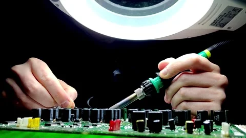 HANDS SOLDERING CIRCUIT BOARD / ELECTRONICS / REPAIR LABORATORY Stock Footage 256734157