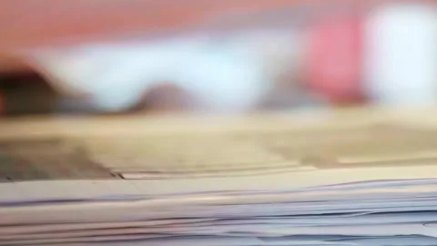 Hands sorting paperwork, flipping through office documents and contracts on Stock Footage 332923440