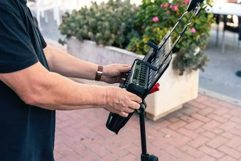 Hands of a sound technician preparing a device for a concert Stock Photos